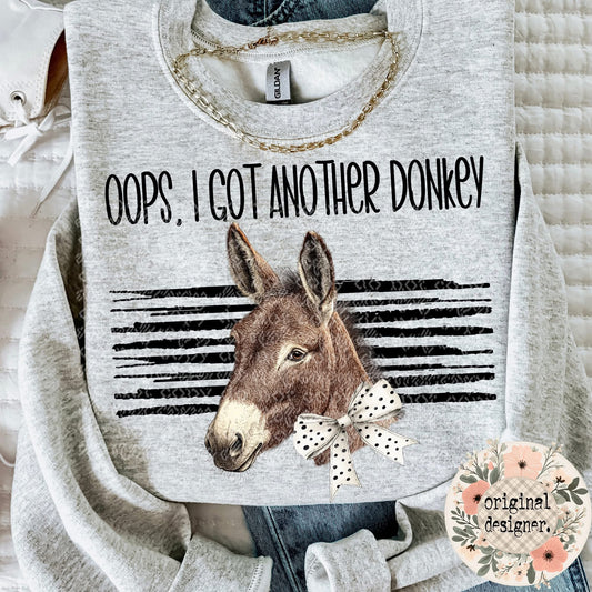 Gray sweatshirt with a donkey graphic and text 'Oops, I got another donkey' on a light background.