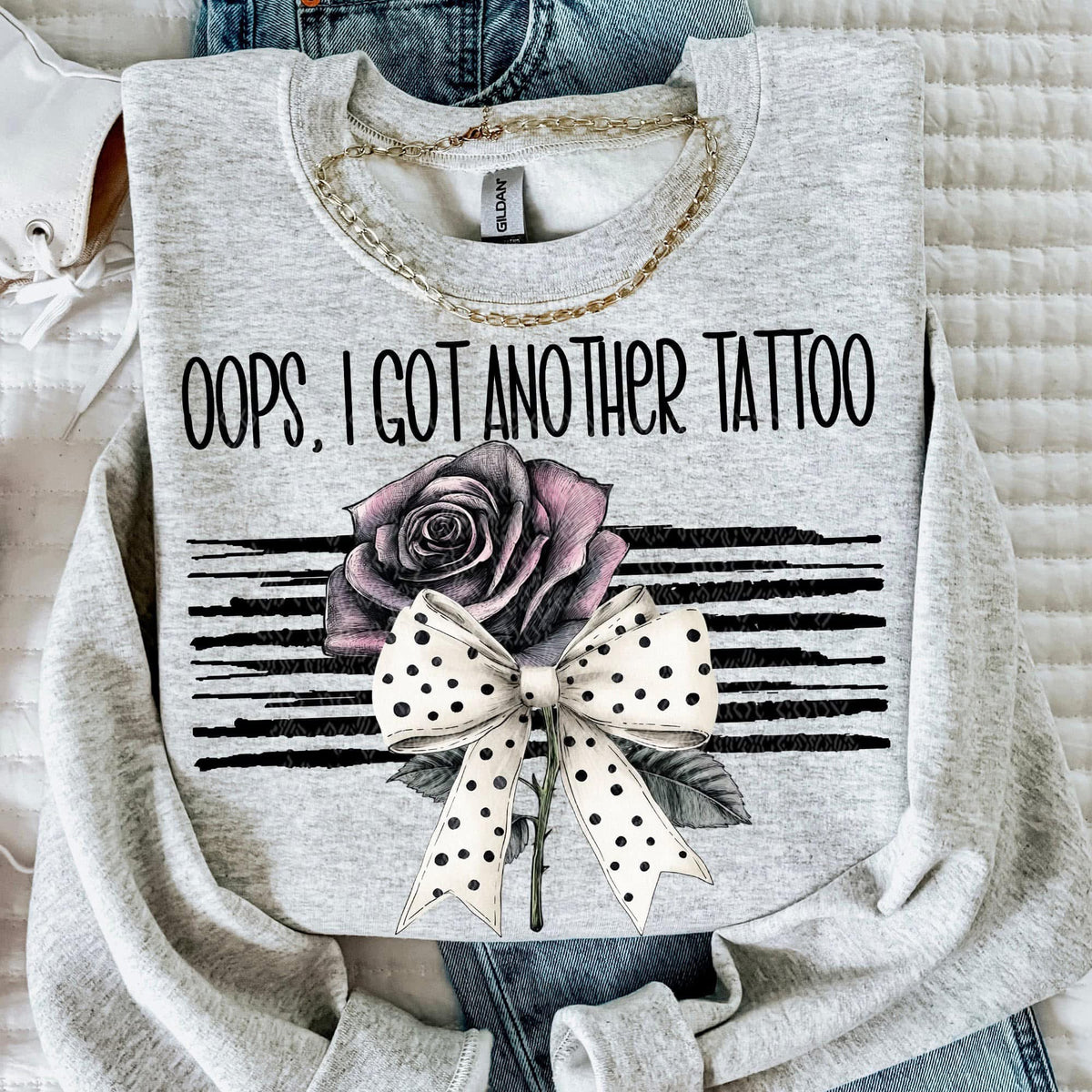 Gray sweatshirt with a rose, polka dot bow, and key design on a white background