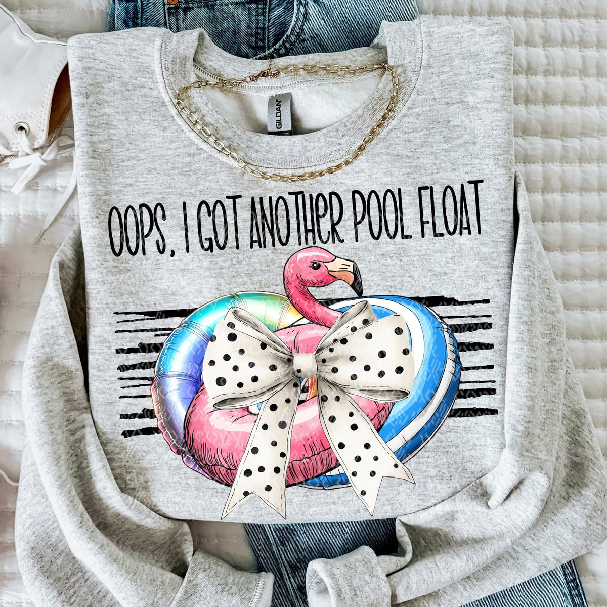 Gray sweatshirt with flamingo and pool float graphic and text 'Oops, I got another pool float'.