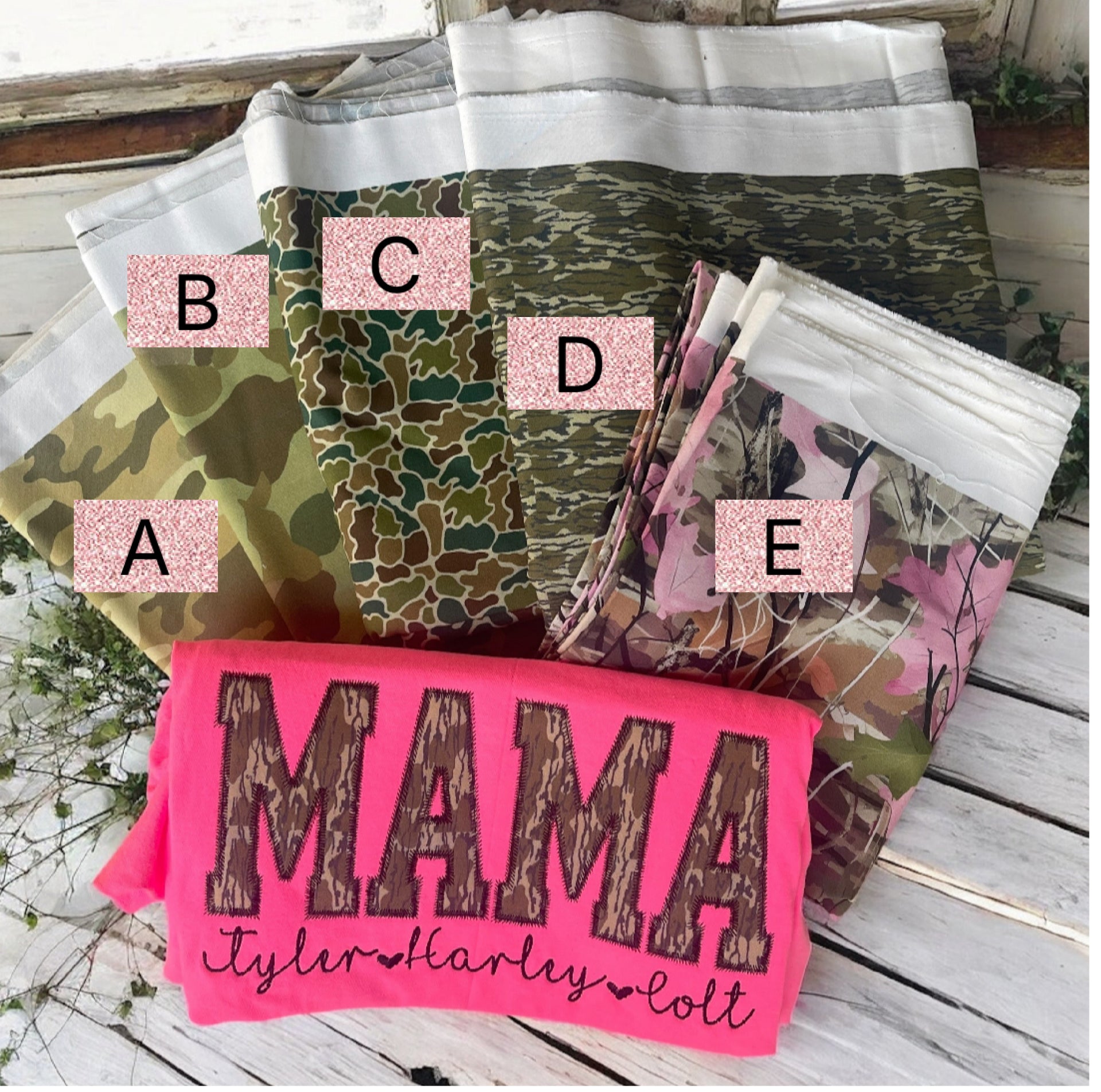 Collection of patterned bags with labels on a wooden surface, featuring a pink 'MAMA' bag.