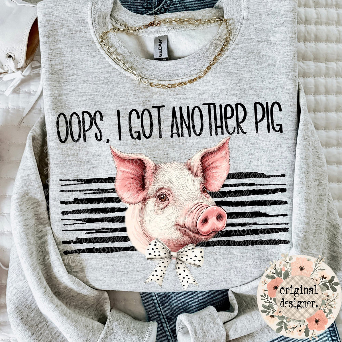 Gray sweatshirt with a pig graphic and text 'Oops, I got another pig' on a light background.