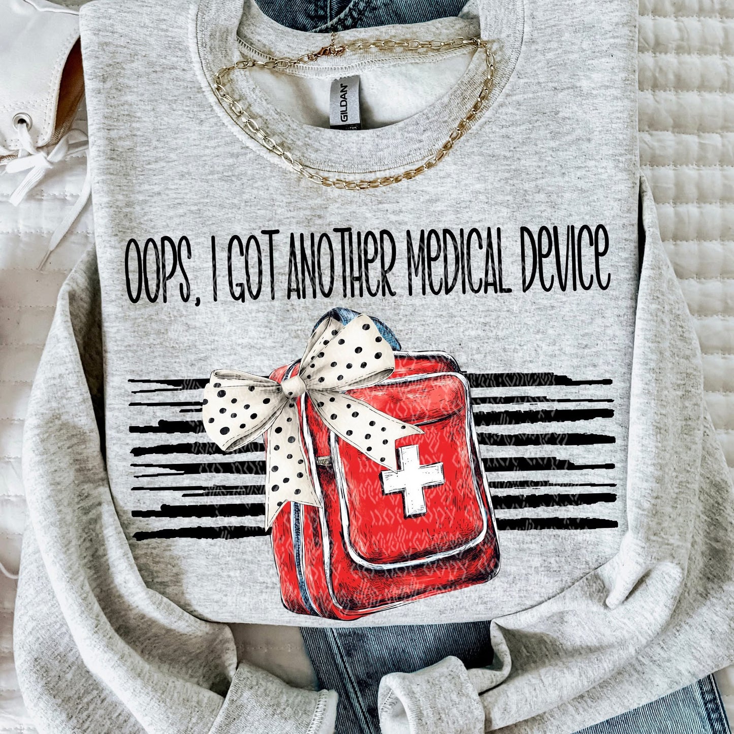Gray sweatshirt with a red medical bag graphic and text 'Oops, I got another medical device' on a white background.